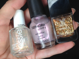 Step 1: Gather your ingredients — one base color and two complementary sparkly things — and apply two coats of your base color over a base coat like this. It doesn’t really matter what colors you choose, but here I went for a purple pastel and gold-ish scheme.